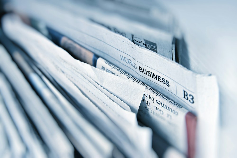 Historical newspapers spread on table